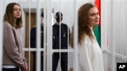 Belsat TV journalists Darya Chultsova (left) and Katsyaryna Andreyeva, who were detained in November while reporting on anti-government protests, attend their trial in Minsk last month.