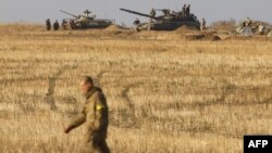 Ukrainian servicemen man positions with APCs and tanks near the town of Debaltseve, in the Donetsk region, on September 21.