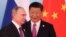 Chinese President Xi Jinping (right) stands next to Russian President Vladimir Putin as he arrives for a group photo during the BRICS Summit in Xiamen on September 4. 