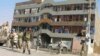 U.S. soldiers and Afghan security forces stand guard outside a Kabul Bank branch in Kandahar. (file photo)