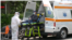 Romanian paramedics transport a patient with covid-19 symptoms to a hospital