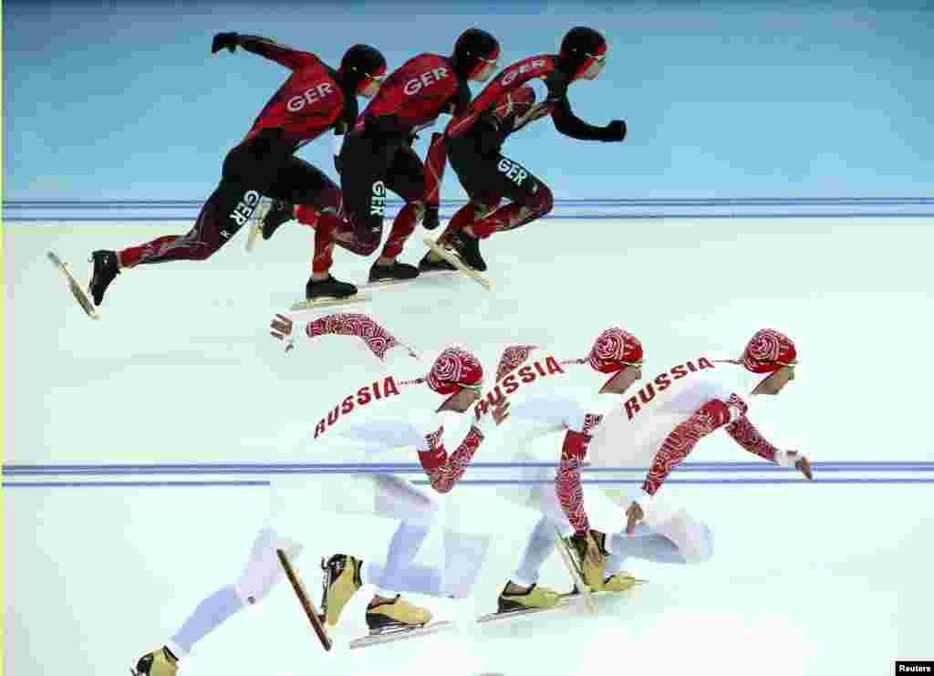 Germany&#39;s Samuel Schwarz (top) and Aleksei Yesin of Russia compete in race 1 of the men&#39;s 500-meters speed-skating event.