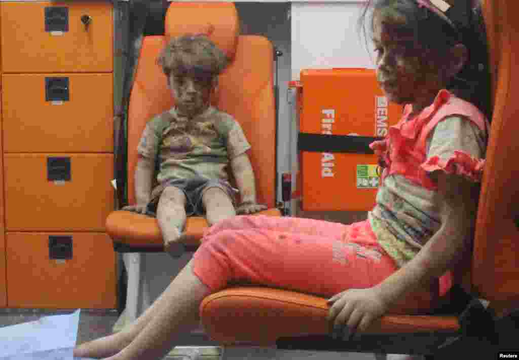 Five-year-old Omran Daqneesh, bewildered, covered in dust and with a bloodied face, sits with his sister inside an ambulance after they were rescued following an air strike in the rebel-held Al-Qaterji neighborhood of Aleppo, Syria. He and his sister were not seriously wounded, but officials said Omran&#39;s brother, Ali, who was 10, died from injuries suffered in the same attack. Images of Omran were widely circulated on social media and drew further attention to the plight of civilians in Syria&#39;s ongoing civil war. (Reuters/Mahmoud Rslan)