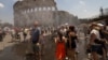 Ljudi se rashlađuju u blizini Koloseuma dok italijanska civilna zaštita primjenjuje mjere kako bi pomogla stanovnicima i turistima da se nose s toplotnim talasom, u Rimu, 26. juna 2026.