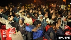 Indian fishermen, who were released by the Pakistani authorities, wave after crossing over to the Indian side of the India-Pakistan border, near Amritsar on December 29. 