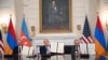 US President Donald Trump (C), Azerbaijani President Ilham Aliyev (L) and Armenian Prime Minister Nikol Pashinyan display the agreement they signed in the State Dining Room of the White House in Washington, DC on August 8, 2025.