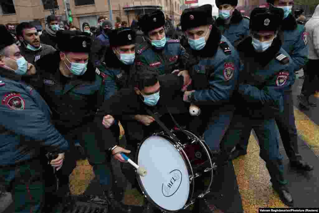 A protester is taken away by Armenian law enforcement officers during an opposition rally to demand the resignation of Prime Minister Nikol Pashinian following the signing of a deal to end the military conflict over Nagorno-Karabakh, in Yerevan on December 8. (Vahram Baghdasaryan/Photolure via Reuters)