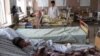 Men who were injured in a bus accident receive medical treatment at a hospital in Kandahar on April 26.