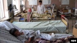 Men who were injured in a bus accident receive medical treatment at a hospital in Kandahar on April 26.