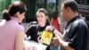 Armenia - An anti-smoking campaigner talks to passersby in Yerevan, 31May2011.