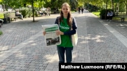 A volunteer for Pivovarov’s campaign handing out leaflets promoting his political party, Yabloko