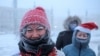 Russia -- Participants of the New Year's Eve race run gather near a Christmas tree, after the temperature went below minus 47 degrees Celsius