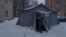 A Ukrainian rescue worker in Kyiv opens a tent at a so-called point of invincibility, where people can charge mobile devices and keep themselves warm amid harsh winter conditions in the city. 