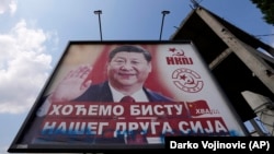 A billboard showing Chinese leader Xi Jinping says: “We want a bust of our comrade Xi" and “Thank you” in Belgrade in August 2021.
