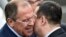 Serbian Foreign Minister Ivica Dacic (right) welcomes his Russian counterpart Sergei Lavrov at Belgrade's airport on June 16. 