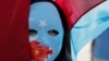 Turkey -- File photo -- An ethnic Uyghur demonstrator wears a mask as she attends a protest against China in front of the Chinese Consulate in Istanbul, Turkey, October 1, 2019