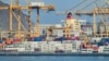 Containers are stacked along a pier at the Khor Fakkan Container Terminal along the Gulf of Oman on June 19..