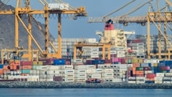 Containers are stacked along a pier at the Khor Fakkan Container Terminal along the Gulf of Oman on June 19..