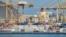 Containers are stacked along a pier at the Khor Fakkan Container Terminal along the Gulf of Oman on June 19..