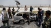 Afghan officials inspect a vehicle from which insurgents fired rockets in a deadly attack in Kabul on August 18.