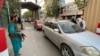 Taliban members check vehicles at the entrance to the Green Zone where most foreign embassies are situated in Kabul on August 22, days after the militant group seized control of the Afghan capital. 