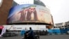 FILE PHOTO: A man on a motorcycle looks at a large billboard featuring Iran's new Supreme Leader Mojtaba Khamenei, in Tehran