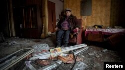 Natalia, 67, sits inside her house, which was destroyed by a Russian missile strike, in Kramatorsk on December 17.