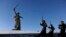 Honor guards march past the giant monument built to honor those who died in the World War II Battle of Stalingrad.