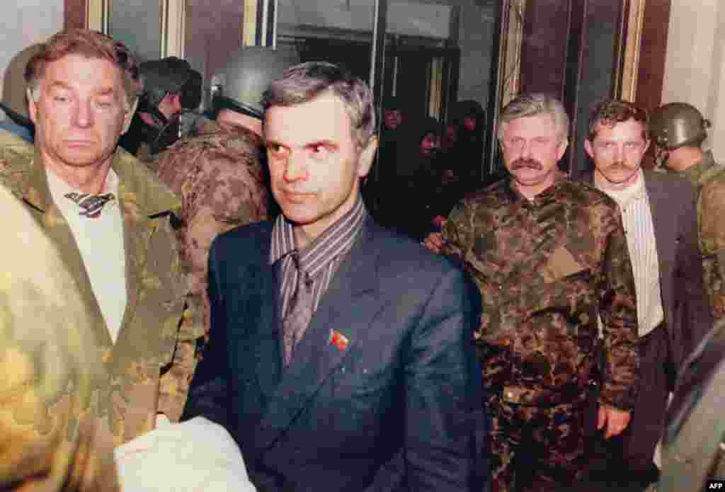 Former parliament chairman Ruslan Khasbulatov (second from left) and former Vice President Aleksandr Rutskoi (third from right) being escorted from the parliament building on October 4.&nbsp;