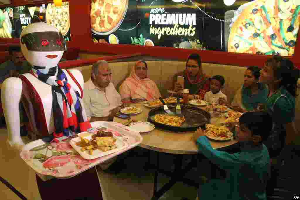 A prototype robot waitress delivers food at a pizza restaurant in Multan, Pakistan. (AFP/SS Mirza)