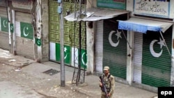 A soldier patrols a Mingora street, in Swat Valley, during curfew hours on April 20.