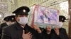 Servants of the holy shrine of Imam Reza carry the coffin of Iranian nuclear scientist Mohsen Fakhrizadeh during his funeral procession in the northeastern city of Mashhad on November 29. Fakhrizadeh was assassinated on the outskirts of Tehran two days earlier. 