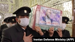 Servants of the holy shrine of Imam Reza carry the coffin of Iranian nuclear scientist Mohsen Fakhrizadeh during his funeral procession in the northeastern city of Mashhad on November 29. Fakhrizadeh was assassinated on the outskirts of Tehran two days earlier. 