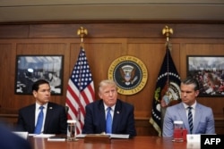 US President Donald Trump, alongside Secretary of State Marco Rubio (left) and Secretary of Defense Pete Hegseth (right), speaks at a Cabinet meeting at Camp David in Maryland on July 31.