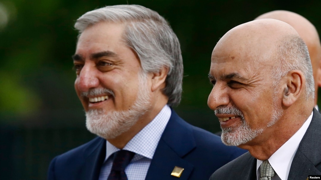 Afghan President Ashraf Ghani (right) with the country's Chief Executive Officer Abdullah Abdullah as they arrive for the NATO summit in Warsaw in July 2016.