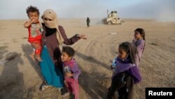 Iraqi civilians return to their village south of Mosul after it was liberated from Islamic State militants on October 21. 