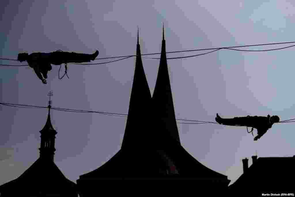 People balance on a slackline over the Emmaus Monastery in Prague. (epa-EFE/Martin Divisek)