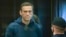 Russian opposition leader Aleksei Navalny stands in the cage during a court hearing in Moscow earlier this year. 