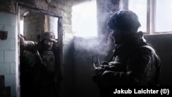 Convict soldiers pause for a cigarette at the training facility.
