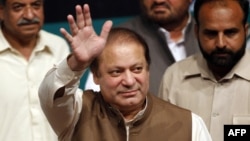 Pakistan's incoming prime minister, Nawaz Sharif, waves to his party's newly elected MPs in Lahore on May 20.