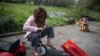 FRANCE -- Children play on the terrasse of their home in Lavau-sur-Laure, western France, on March 28, 2020, as the France is under lockdown to stop the spread of the Covid-19 pandemic caused by the novel coronavirus. 