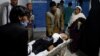 An injured schoolgirl is transported to a hospital after the blast in Kabul.