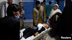 An injured schoolgirl is transported to a hospital after the blast in Kabul.