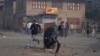 Kashmiris throw rocks at security personnel during a protest in Srinagar in August 2019.