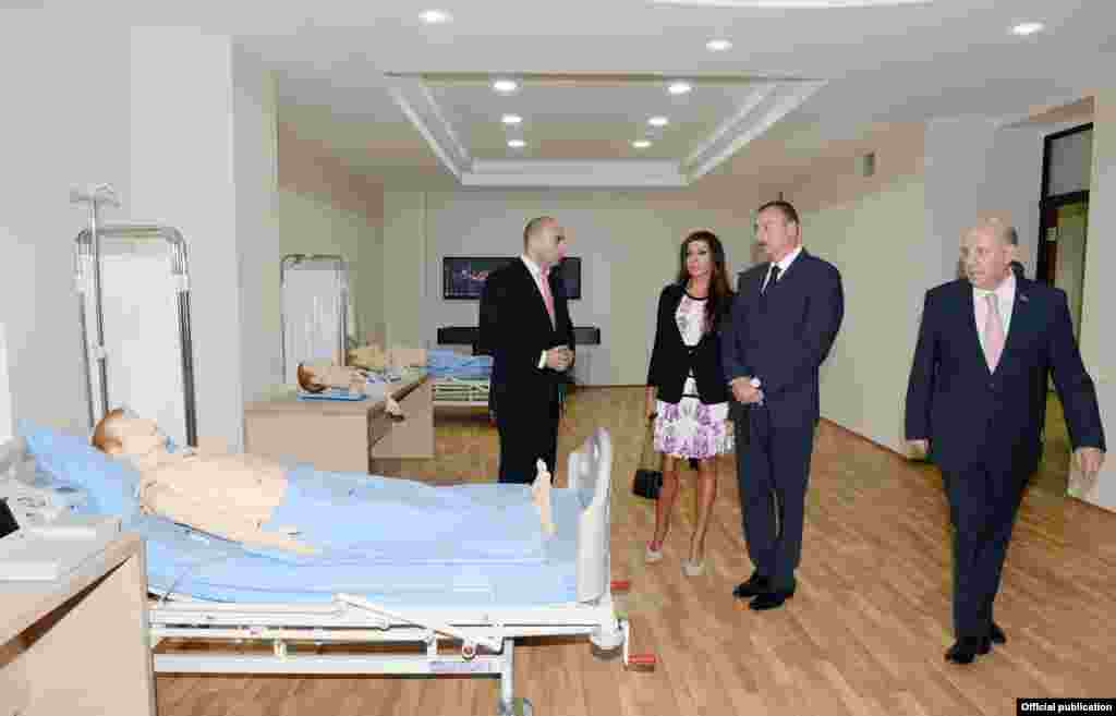 Aliyev's public appearances have been largely limited to ribbon-cutting ceremonies at public buildings, many of which have undergone recent renovations paid for by the presidential reserve fund. Aliyev and his wife visit the opening of a new hospital in Baku on September 12 -- with mannequins standing in as makeshift patients. 
