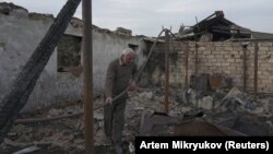 A man stands in the ruins of his farm, which was destroyed by shelling near the village of Taghavard in Nagorno-Karabakh.