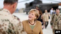 Chancellor Angela Merkel talks with a German soldier during a visit to a base in Konduz, in northern Afghanistan, on May 10.