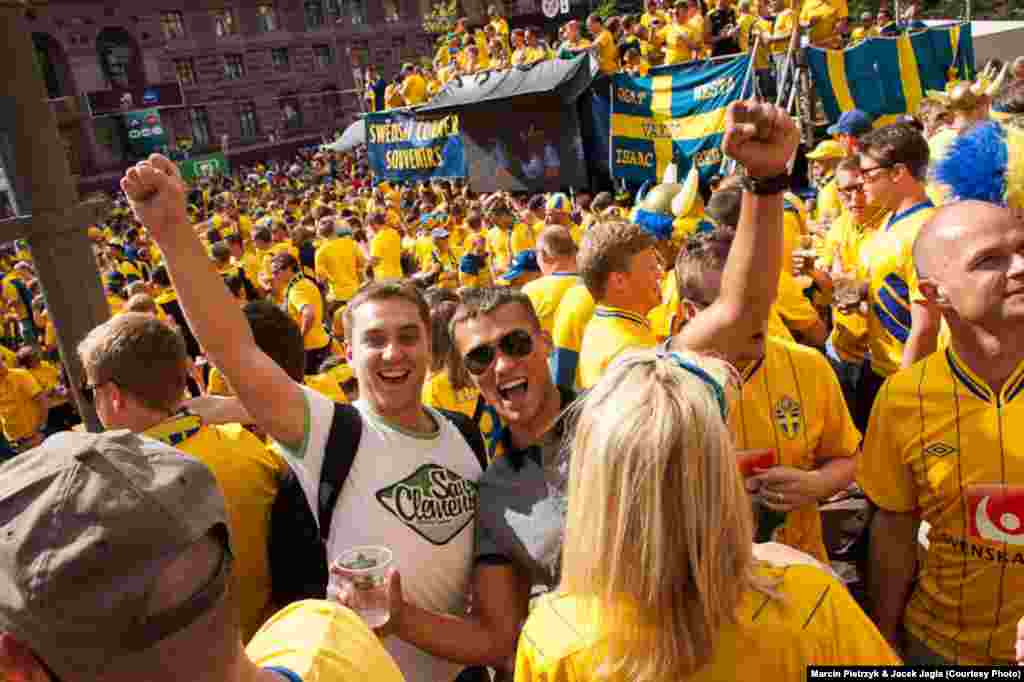 Polish fans Jacek (left) and Piotrek amid a sea of Swedish supporters during the Euro 2012 soccer championships in Kyiv on June 15.