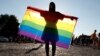 A demonstrator holds a rainbow flag at a rally in Budapest protesting against a law that bans LGBT content and materials in schools. (file photo)