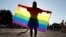 A demonstrator holds a rainbow flag at a rally in Budapest protesting against a law that bans LGBT content and materials in schools. (file photo)